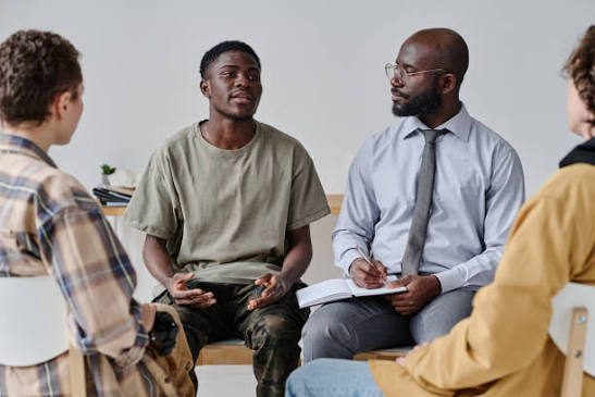 A small group in conversation, led by a clinician.