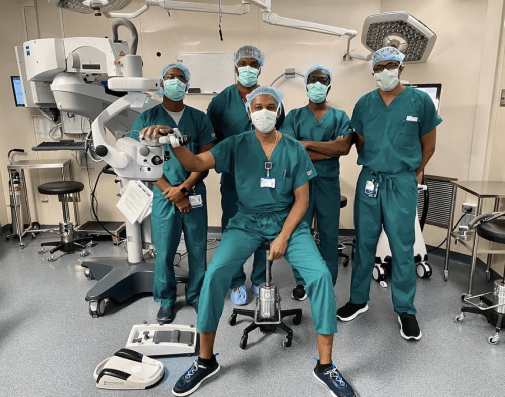 A surgical team in scrubs standing together in an operating room.